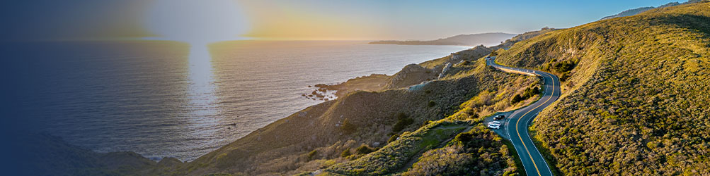Highway 1 winding through a hilly, coastal countryside