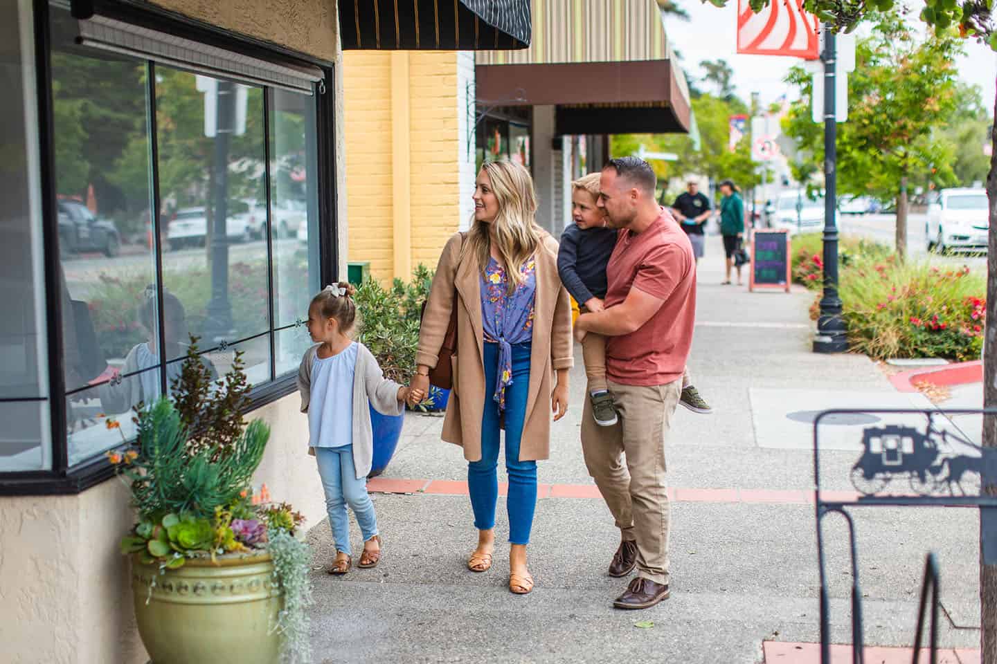 A family strolling through the village of Arroyo Grande