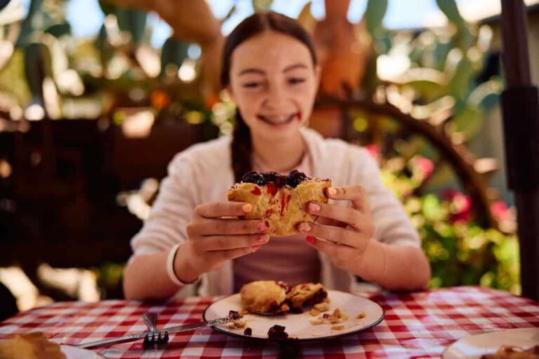 A girl eating a piece of Linn's ollalieberry pie