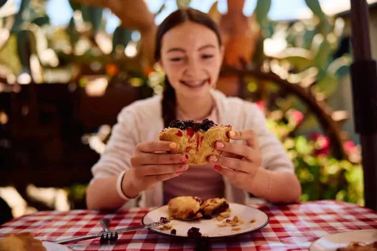 A girl eating a piece of Linn's ollalieberry pie