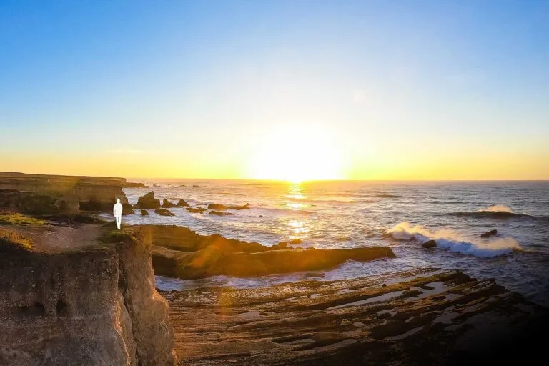 Person on the edge of a cliff at Montana de Oro State Park in California