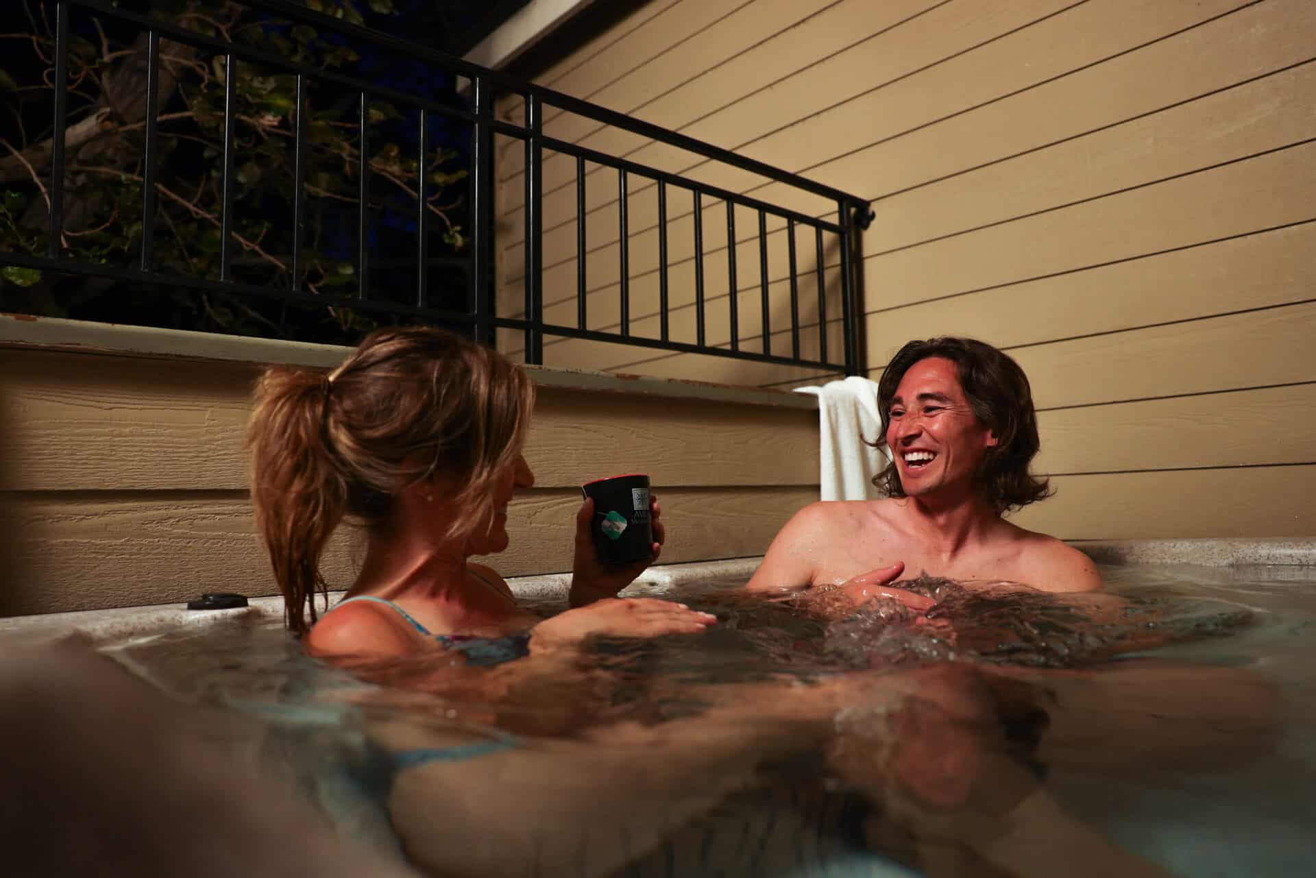 Couple in hot tub at Avila Village Inn